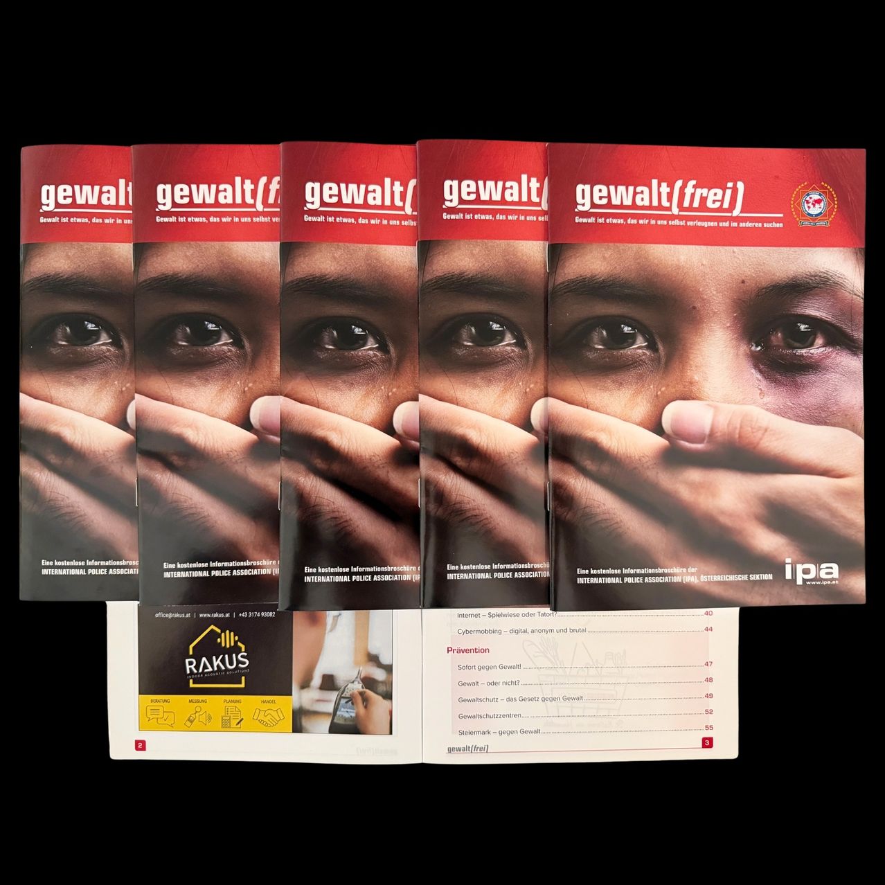 Eine Reihe von Broschüren mit dem Titel 'Gewalt' mit einer Hand, die das Gesicht einer Person bedeckt. Unten ist eine Visitenkarte von Rakus zu sehen.