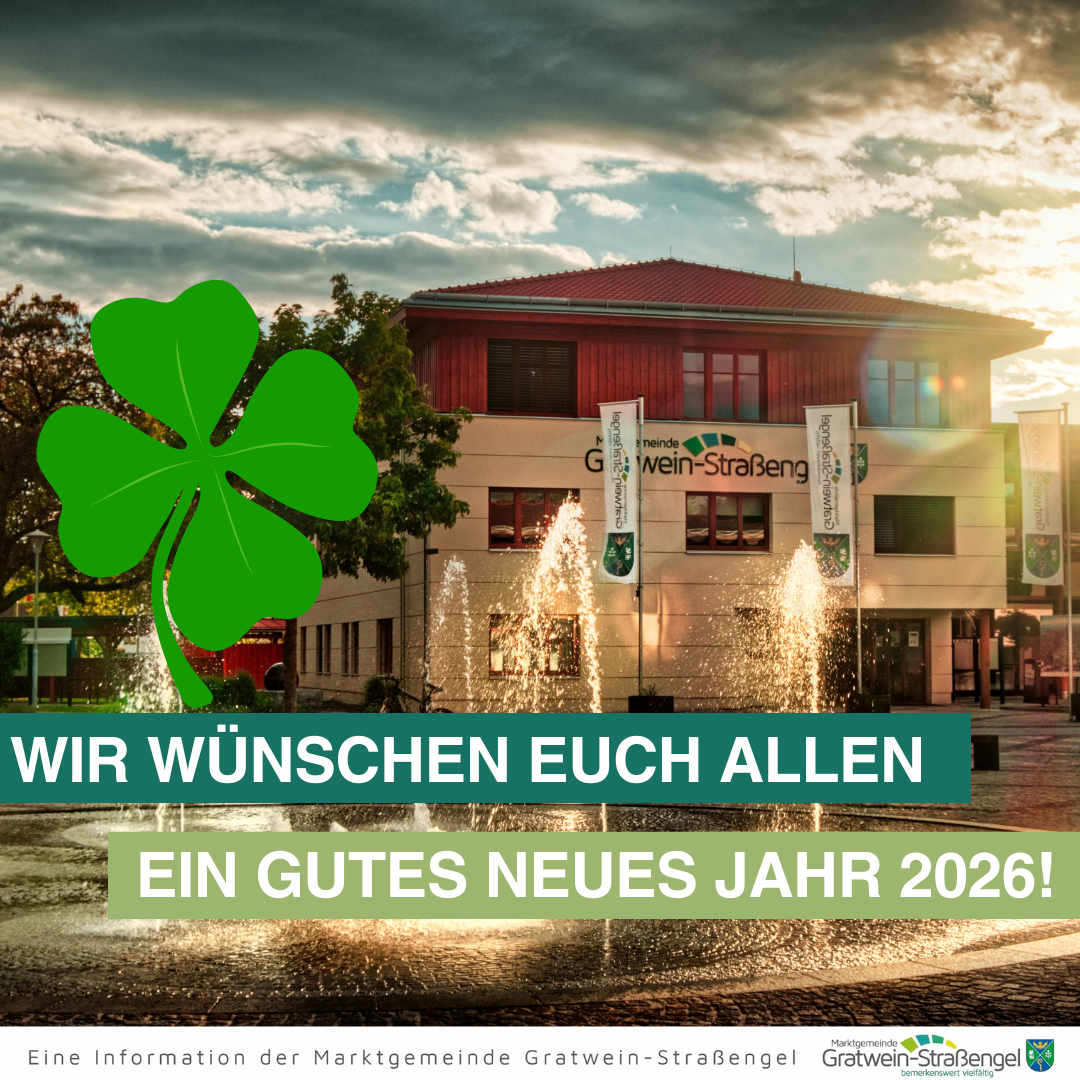 Ein Poster zeigt einen Brunnen mit einem grünen Kleeblatt vor einem Gebäude. Der Text lautet: 'Wir wünschen euch allen ein frohes Neues Jahr 2026!' Das Gebäude hat Fahnen auf Stangen. Das Bild hat einen Wasserzeichen unten.