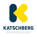 Das Logo für Katschberg zeigt ein stilisiertes 'K' mit einem gelben Pfeil nach oben, vor weißem Hintergrund. Darunter steht 'KATSCHBERG AM HERZEN GELEGEN'.