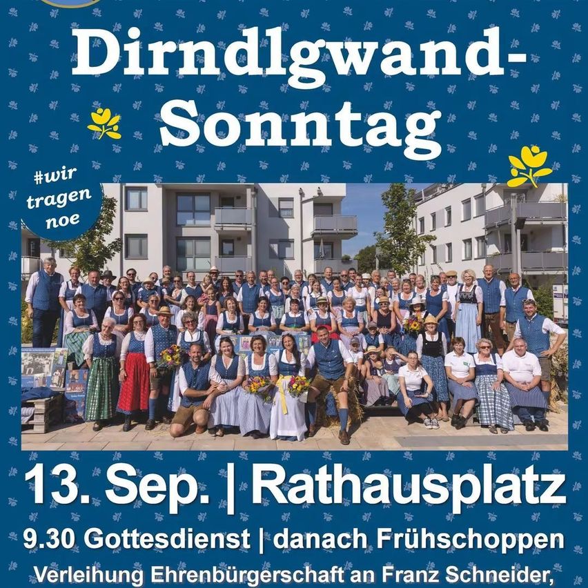 A group of people dressed in traditional Bavarian attire are posing for a photo in front of a building on September 13. The event is called 'Dirndlgwand-Sonntag'.