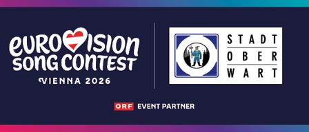 Plakat für den Eurovision Song Contest 2026 in Wien mit dem Logo und einem roten Herz und dem Stadtwappen.