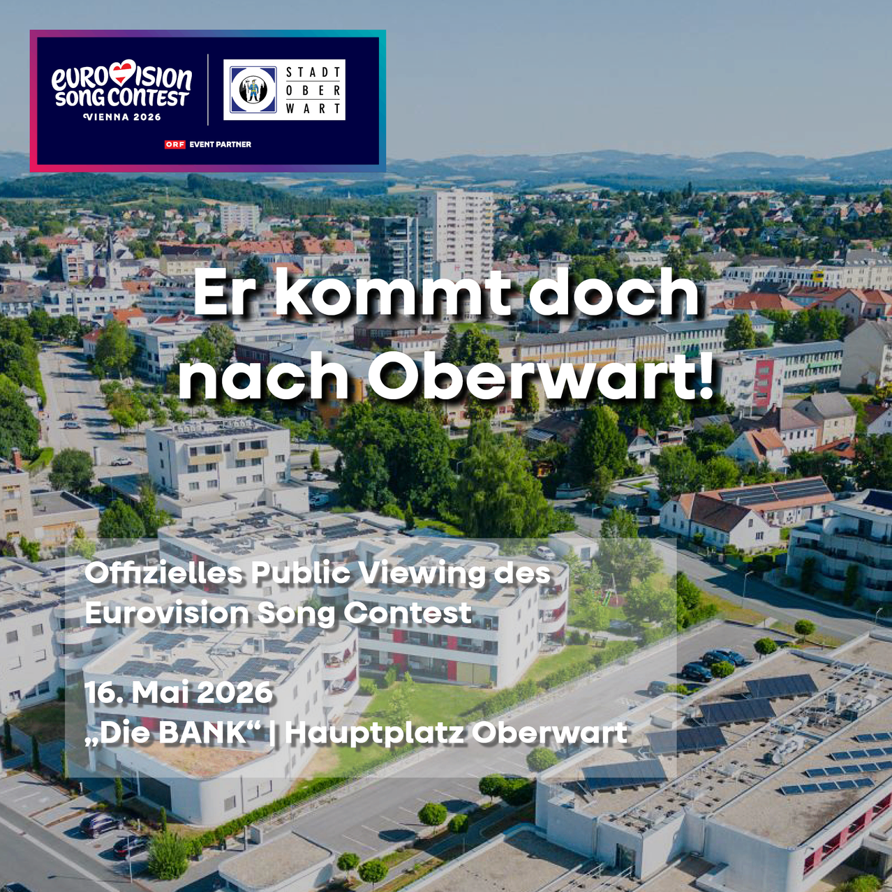 Plakat für den Eurovision Song Contest 2026 in Wien, mit der Stadt Oberwart, Gebäuden und Grünflächen, und dem Text 'Er kommt doch nach Oberwart!' und 'Offizielles Public Viewing des Eurovision Song Contest 16. Mai 2026, Die BANK Hauptplatz Oberwart.'