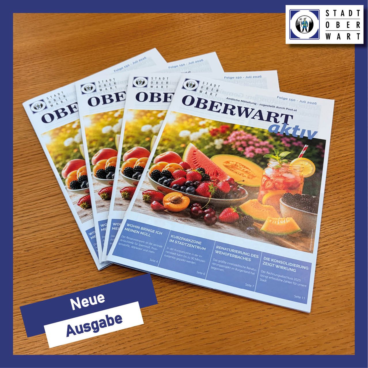 A stack of Oberwart city brochures on a wooden table. They feature fruits, flowers, and a refreshing drink. The brochures have different issues.
