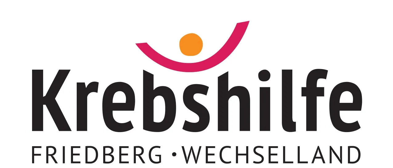 Das Logo für Krebshilfe, mit einem stilisierten Smiley-Gesicht und einer Sonne in der Mitte, begleitet von dem Text 'Friedberg Wechselland'.