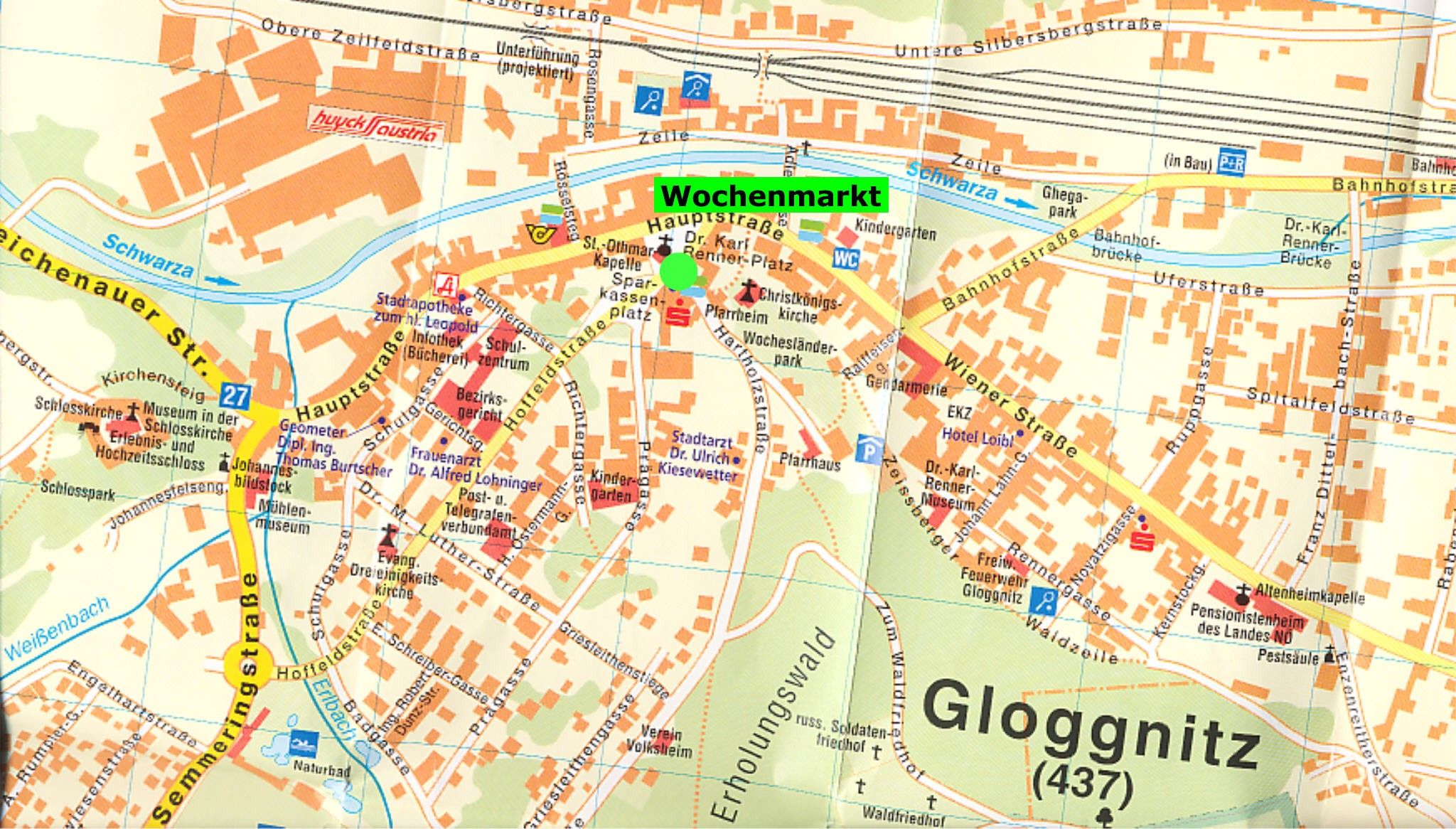 Eine Stadtkarte mit hervorgehobenen Bereichen einschließlich 'Wochenmarkt' und 'Gloggnitz'. Sie zeigt Straßen, Parks und Sehenswürdigkeiten. Die Karte enthält eine Legende mit Symbolen für verschiedene Einrichtungen.