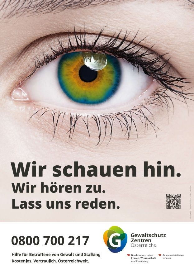 Advertisement with a close-up of an eye featuring multilingual text. The eye has striking blue and green iris. The caption reads, 'We see him. We hear him. Let us speak.' Below, a phone number and a logo for 'Gewaltschutz Zentrum Österreich' are displayed. QR code present.