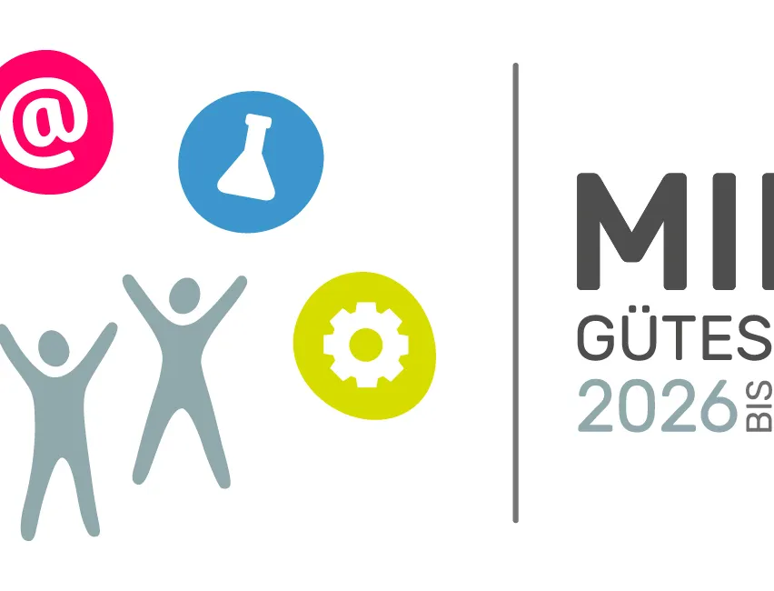 Eine Illustration von zwei Menschen, die ihre Hände heben, mit verschiedenen Symbolen um sie herum, einschließlich eines Dreiecks, eines Kolbens und eines Zahnrads. Der Text lautet 'MINT GUTESIEGEL 2026 BIS 2029'.