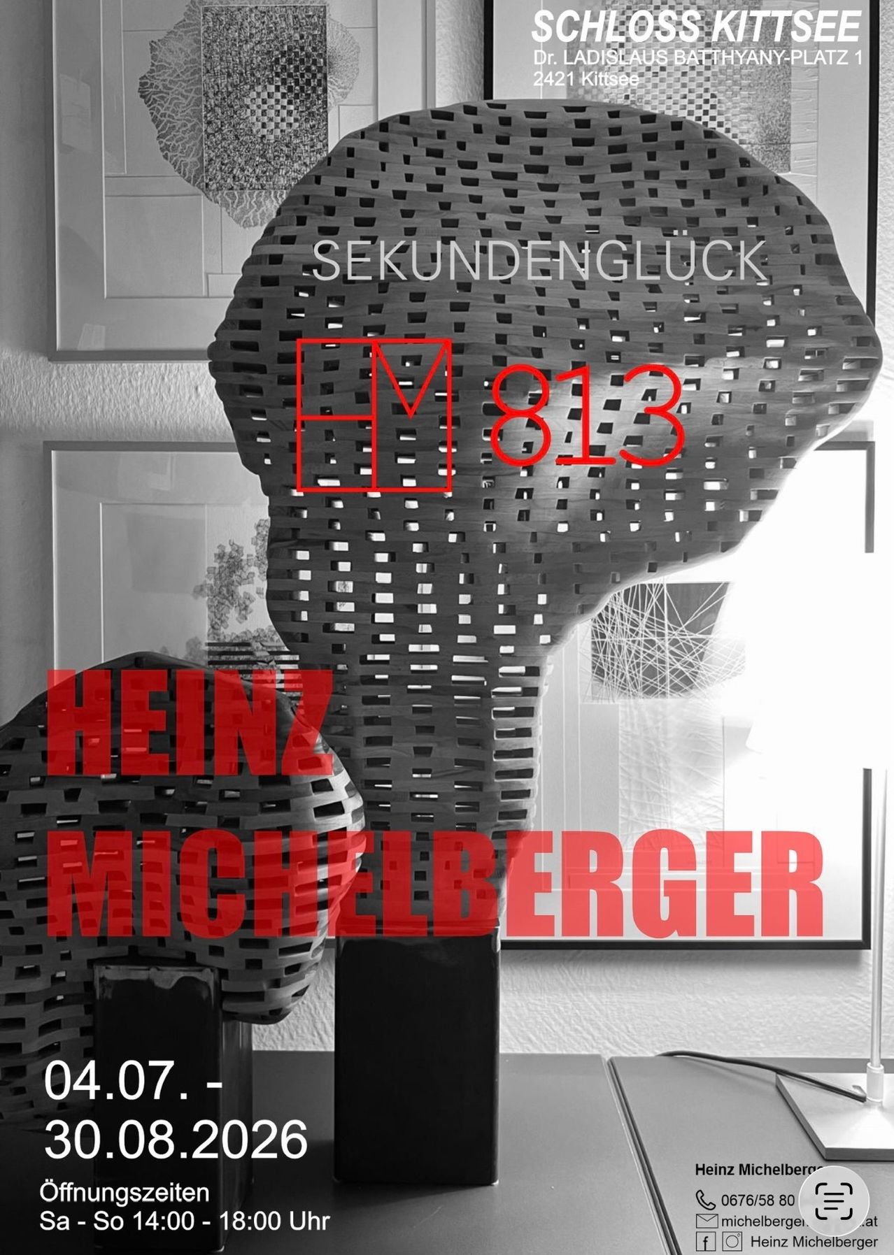 A black-and-white image displays a geometric sculpture labeled 'Sekundenglück'. Below, red text reads 'HM 813' and 'Heinz Michelberger'. The background shows a window and a framed picture.