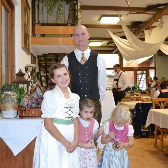 Bild enthält, Dining Room, Dining Table, Table, Potted Plant, Portrait, Restaurant, Wood, Dress, Linen, Flower Arrangement