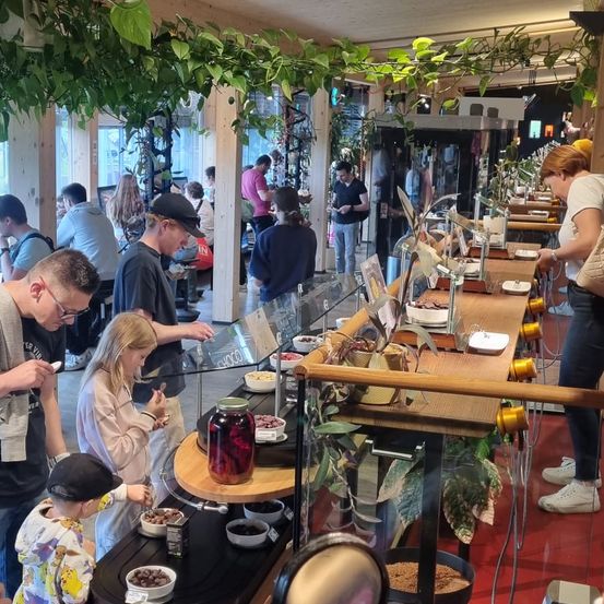 Indoors, Restaurant, Cafe, Dining Table, Table, Cafeteria, Urban, Dining Room, Potted Plant, Person