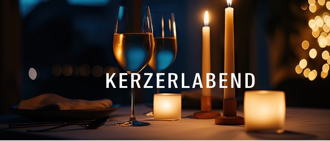 A table with two glasses of wine, two small candles, and one larger candle. The table is set up for a romantic evening. The word 'Kerzerlabend' is displayed prominently.