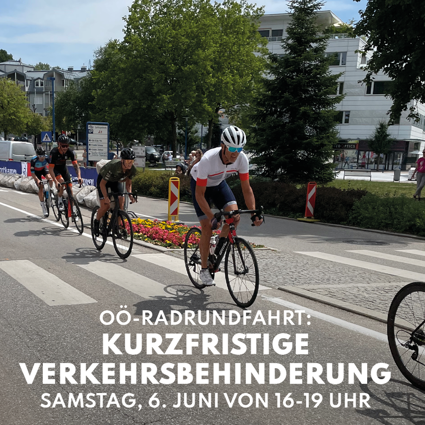 A group of cyclists are riding down the street. There is a pedestrian crossing in the foreground. Text at the bottom indicates a temporary traffic obstruction on June 6th.