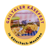 Das Gailtaler Kasefest-Logo ist rund und in Gelb und Weiß gehalten. Es zeigt verschiedene Käsesorten, Früchte und eine Website-Adresse. Der Text ist auf Deutsch.