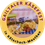 Gailtaler Käsefest-Logo. Rundes Logo für das Gailtaler Käsefest mit einer Auswahl an Käse, Trauben und anderen Lebensmitteln auf einem blau-weiß karierten Tischtuch. Die URL www.kaesefest.at ist ebenfalls angezeigt.