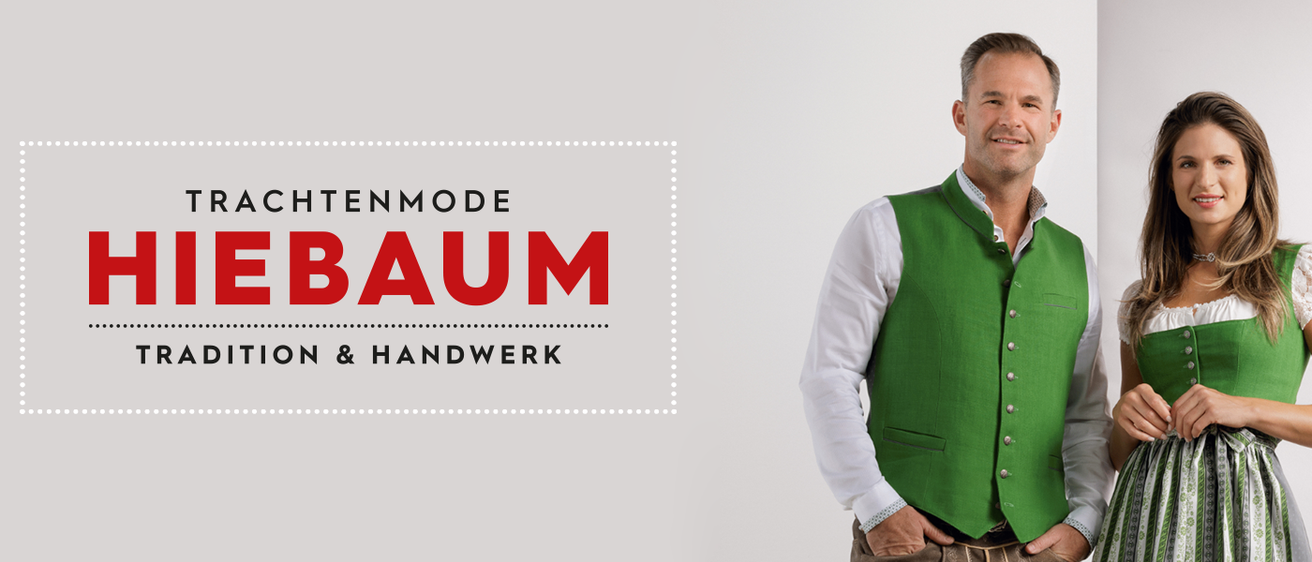 Ein lächelnder Mann in einem weißen Hemd und grüner Weste steht vor einem weißen Hintergrund. Die Worte 'in mode am Handwerk' sind prominent in Rot angezeigt.