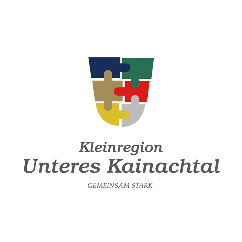 Das Logo für Kleinregion Unteres Kainachtal, mit einem farbenfrohen Puzzleteilschild und dem Slogan 'Gemeinsam Stark'.