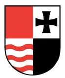 Ein Schild mit einem schwarzen Kreuz auf weißem Hintergrund, roten Wellenlinien auf schwarzem Hintergrund und einem roten oberen Abschnitt.