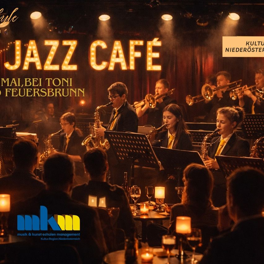 Eine Gruppe von Musikern tritt auf der Bühne im Jazz Cafe auf, mit verschiedenen Instrumenten und einem Scheinwerfer, der den Bereich beleuchtet. Das Publikum sitzt an Tischen und genießt Wein und Kerzen.