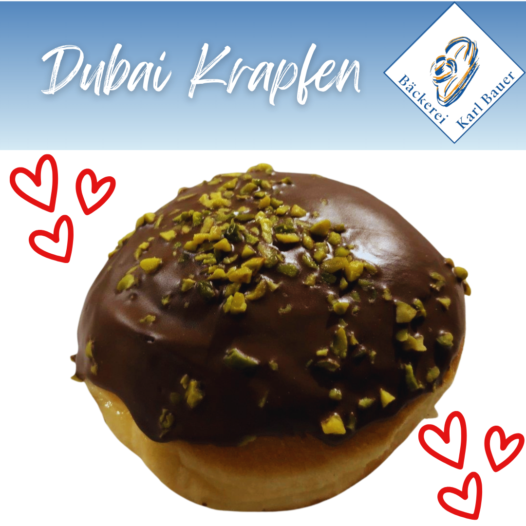A chocolate donut with pistachios and hearts around it, with the words Dubai Krapfen on top and a bakery logo below.
