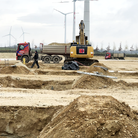 Bild enthält, Machine, Person, Truck, Vehicle, Hat, Worker, Soil, Wheel