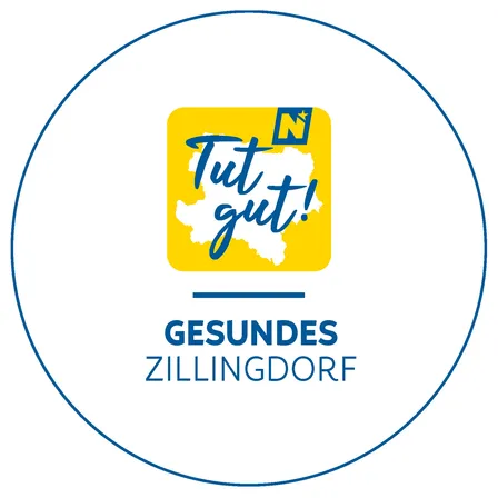 Das Logo von Gesundes Zillingdorf zeigt einen gelben Kreis mit 'Tut gut!' in Blau und dem Namen 'Zillingdorf' darunter.