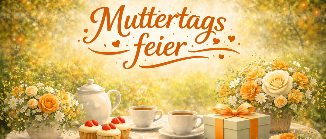 Ein Tisch für den Muttertag, mit Cupcakes, Tee und einem Geschenkbox, vor einem Hintergrund gelber Blumen.