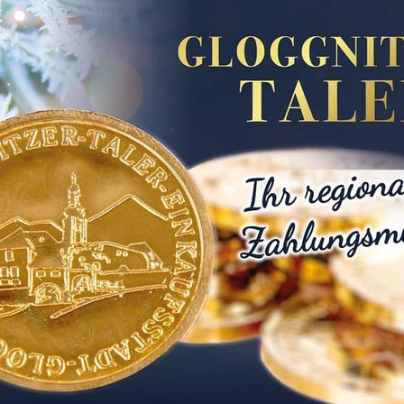 Goldene Münze mit 'GLOGGNITZ TALER' Aufschrift. Sie zeigt ein Gebäude, Berge und den Text '2017 GLOGGNITZ-TALER'. Eine Werbung mit Weißbrotsandwich rechts.