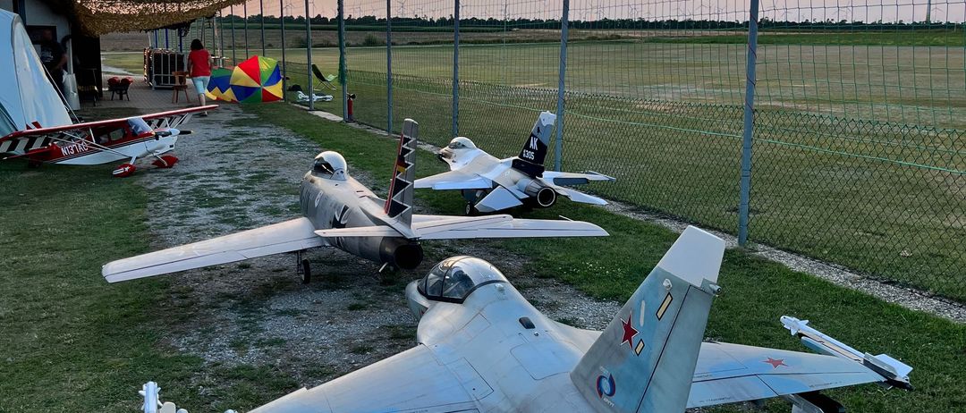 Airport, Airfield, Aircraft, Airplane, Vehicle, Person, Boat, Military Base, Dog