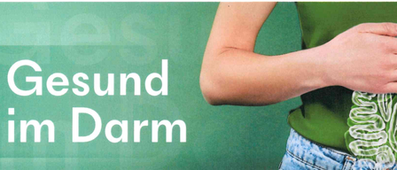 A person with a green top and jeans holding their stomach with a green background with the text 'Gesund am Darm'.