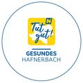Das Logo für Tut gut! Gesundes Hafenbach, mit einem gelben Quadrat, das eine Kartenumrisslinie und den Text Tut gut! in Blau enthält, in einem blauen Kreis.
