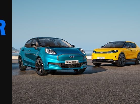 Drei Ford Autos, ein blauer Puma Gen-E, ein gelber Capri und ein grauer Explorer, geparkt in einer malerischen Außenumgebung.