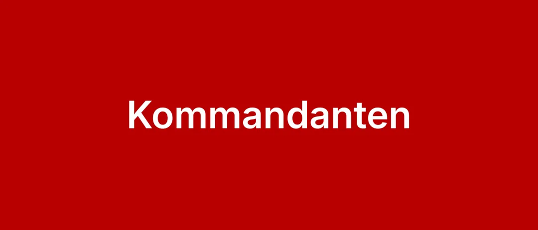 Das Wort 'Kommandanten' ist in Weiß auf rotem Hintergrund geschrieben.