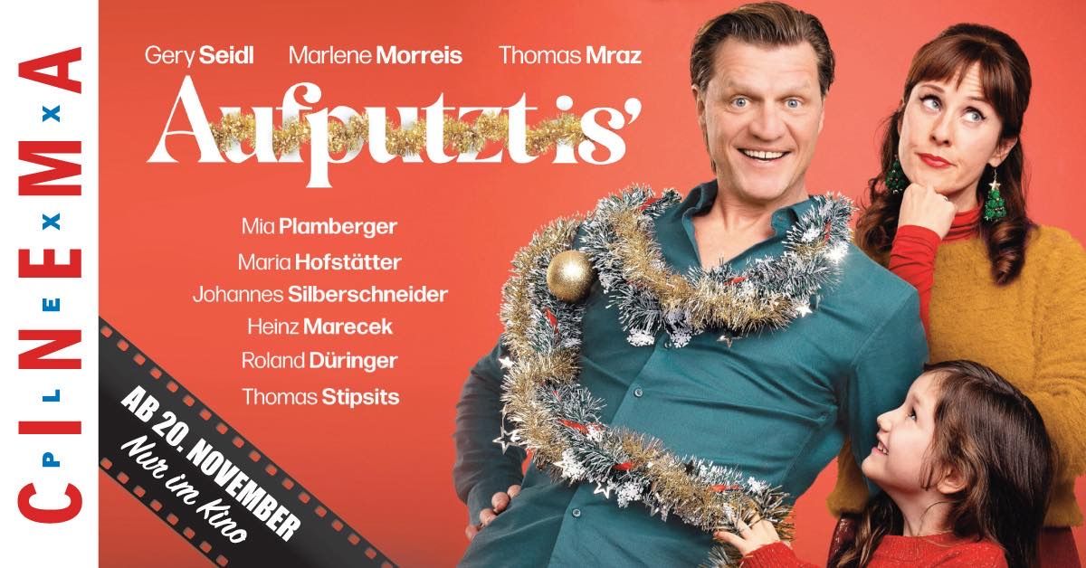 A movie poster features a man wearing a tinsel garland around his neck, smiling, with a child beside him. The title reads Aufputzis. Names of actors are listed below.