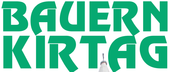 Grüner Text 'Bauern Kirtag' über einer Turmspitze. Darunter steht 'am Hauptplatz in Breitenbrunn'.