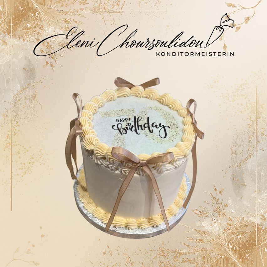 A birthday cake with a white and yellow frosting, a ribbon on top, and a golden background with a design.