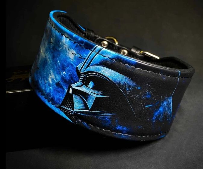 Ein blauer und schwarzer Lederhalsband mit einem Darth Vader-Maskendesign vor einem dunklen Weltraumhintergrund.