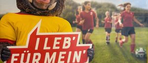 Ein Poster zeigt eine Person in einer Schweinemaske, die ein Schild hält. Das Schild sagt 'Ich lebe für meinen Verein!' vor einem Fußballfeld mit Läufern. Das Poster hat einen gelben Rand und den Text 'Bring It S!' oben.