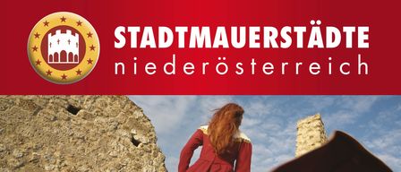 A poster for an event called Aktionstag Stadtmauer. A woman in a red dress stands in front of a stone wall. The event is on Saturday, April 18, 2026, at 2 PM.