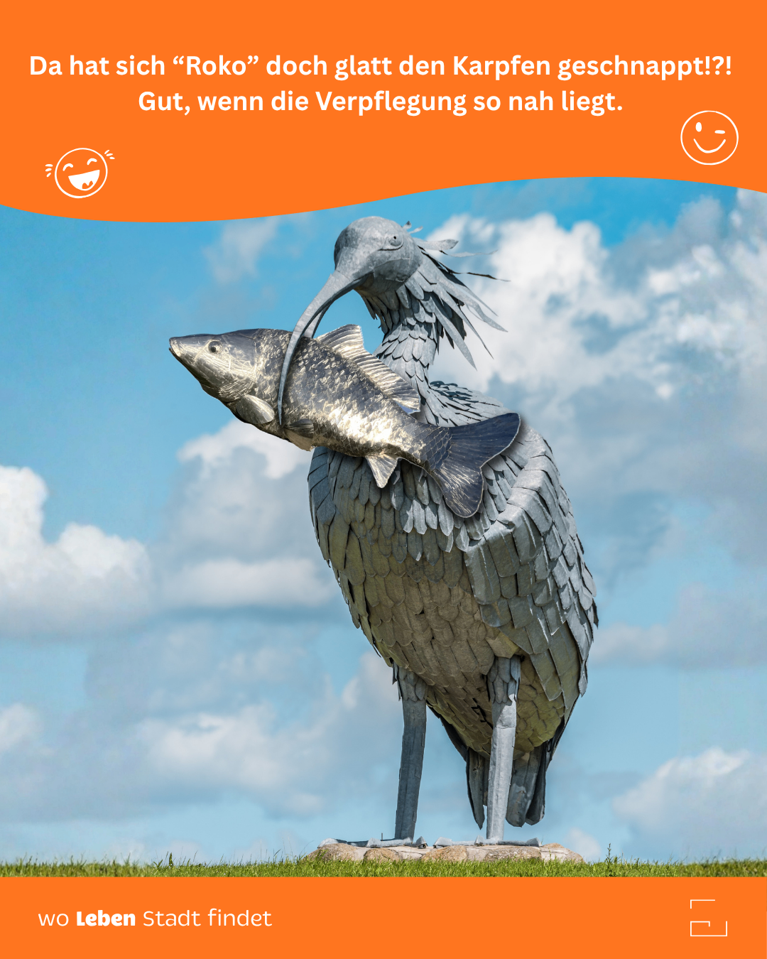 A statue of a bird with a long beak holds a fish in its claws. The sky is blue with clouds.