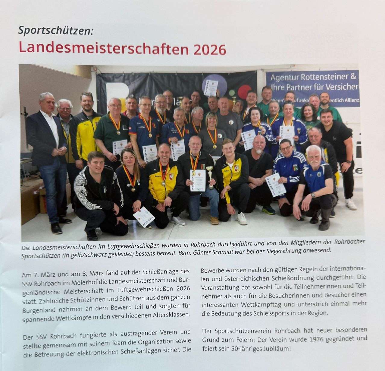 A group of people are posing for a photograph wearing medals and holding certificates. The text on the image reads 'Sportsschützen: Landesmeisterschaften 2026'. The image has a watermark in the bottom right corner.