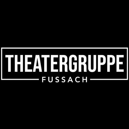 Auf einem schwarzen Hintergrund steht weißer Text 'Theatergruppe Fussach', wobei 'Theatergruppe' oben und 'Fussach' unten steht. Der Text befindet sich in einem weißen Rechteckrahmen.