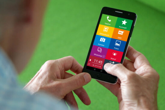 A person is holding a smartphone with icons like call, address book, camera, WhatsApp, photos, and notifications. The screen shows the time 11:45 and the date 01.27.18.