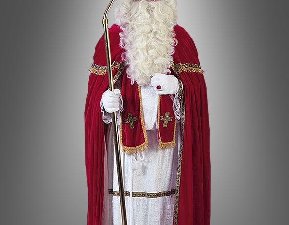 Eine Person in Santa Claus-Kostüm mit rotem Hut, weißem Bart und goldenem Stab posiert für die Kamera.