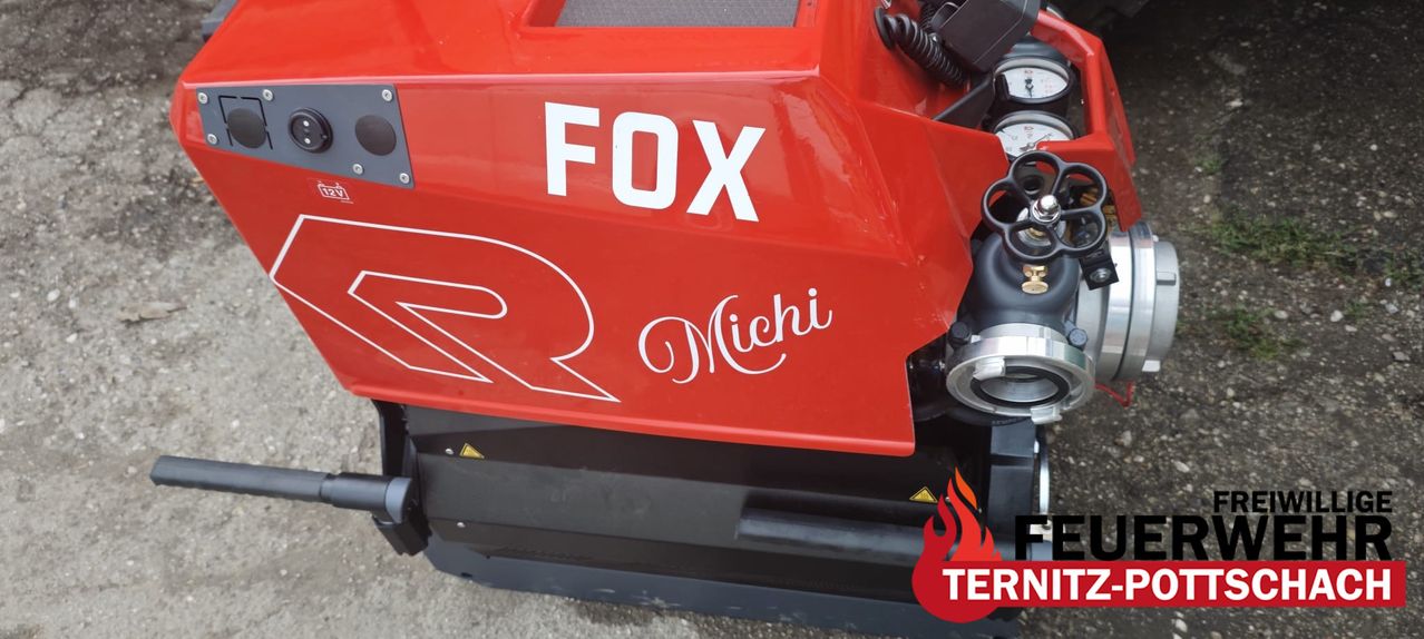 A red vehicle with the word 'FOX' and 'Michi' written in white on it. The vehicle has a black border and a fire symbol on the right side.