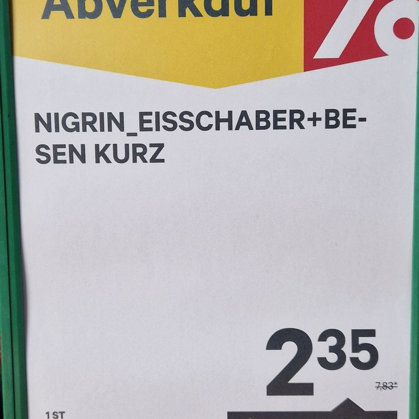 A sale sign for Nigrin ice scrapers and brushes. It says 'Nigrin Ice Scraper+Brush, Short'. The price is 2.35 euros. There's a discount of 7.83 euros.
