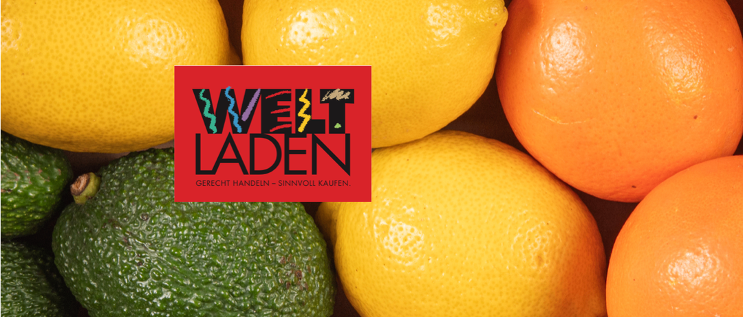 Ein Bild von verschiedenen Früchten, darunter Zitronen, Orangen und eine Avocado, mit einem roten Quadrat, auf dem 'Welt Laden' steht.