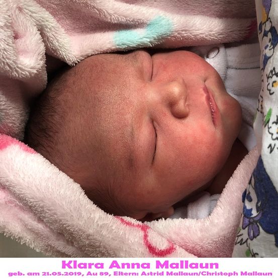 Ein neugeborenes Mädchen namens Klara Anna Mallaun, geboren am 21.05.2019, schläft friedlich in einer rosa Decke mit Blumenmuster eingewickelt.