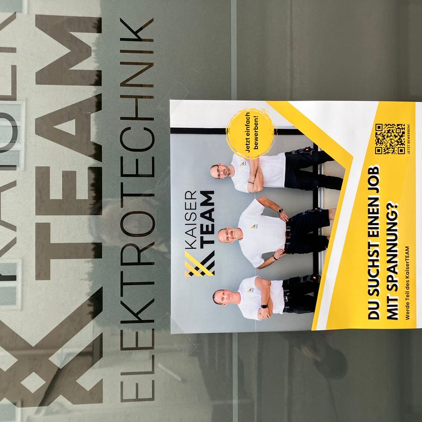 A poster with three men in white shirts and black pants standing together. The poster says 'Du suchst einen Job mit Spannung?' with a QR code.