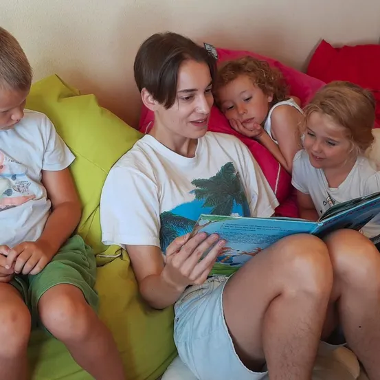 People, Person, Reading, Boy, Child, Male, T-Shirt, Couch, Furniture, Face