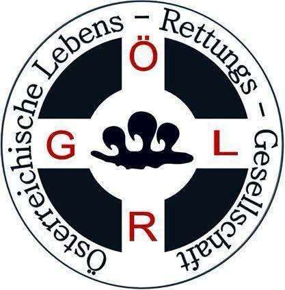 Das Logo zeigt ein Kreuz mit den Buchstaben 'G', 'R' und 'L' oben, in der Mitte und unten. Das Kreuz ist weiß, die Buchstaben rot. Das Logo ist von einem schwarzen Kreis umgeben, auf dem 'Lebens-Rettungs-Gesellschaft' steht.